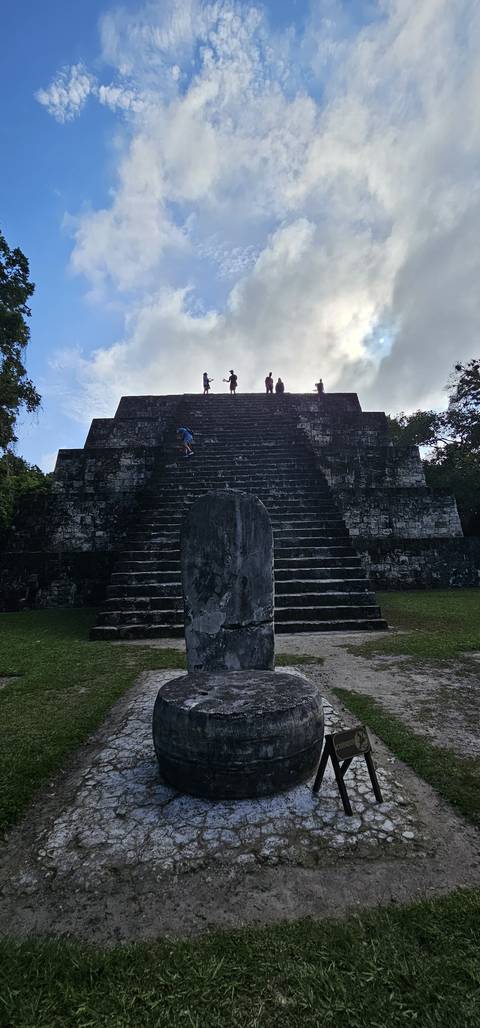 A person standing in front of ancient stone steps possibly in a historical site.