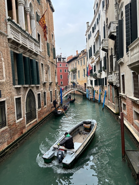 Venetian canal with gondolas and historical buildings.