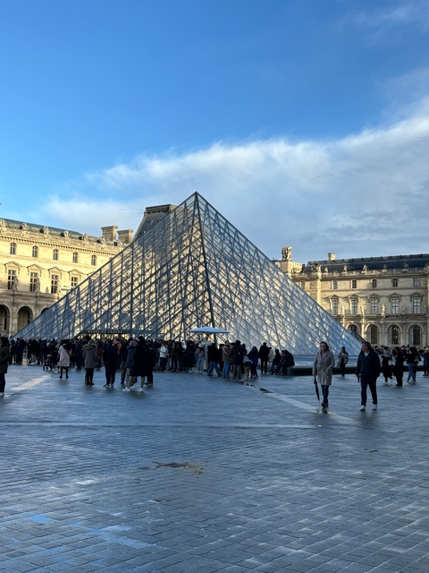 Crowds outside the Louvre Pyramid in Paris.