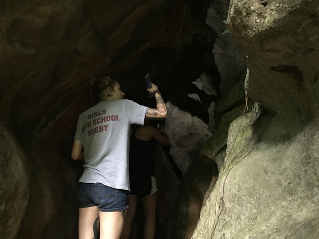 Person exploring inside a cave.