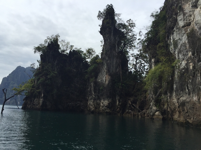 Jagged limestone formations over a lake.