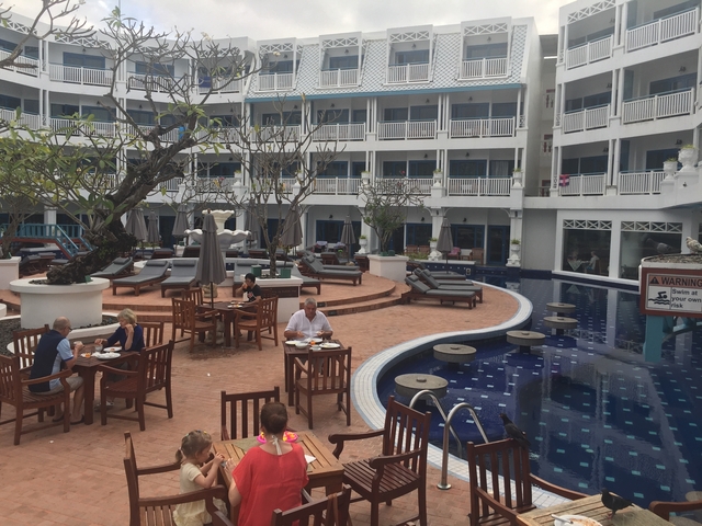 Outdoor dining area at a hotel pool.