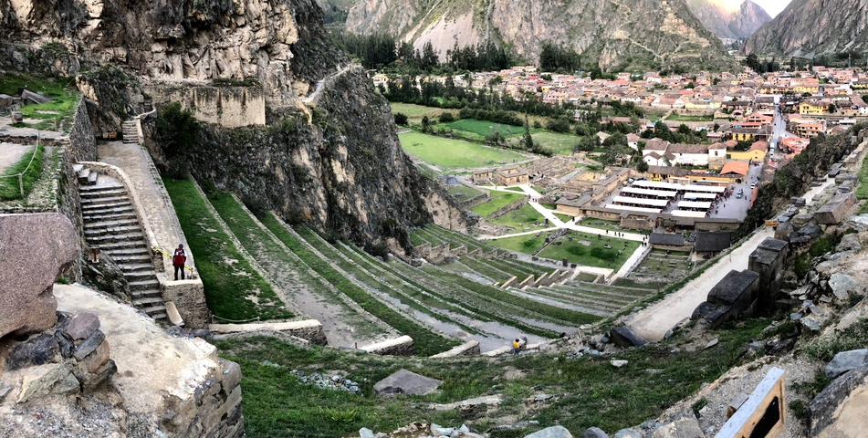 Panoramic view of terraced agricultural fields and ruins.