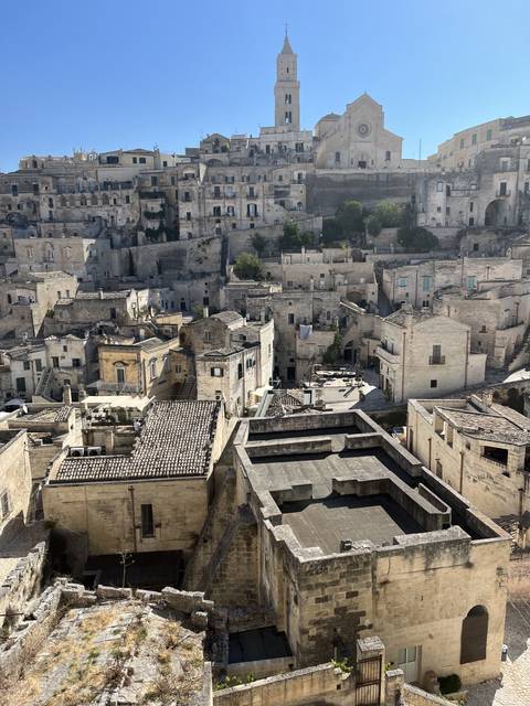 Ancient stone city with a bell tower.