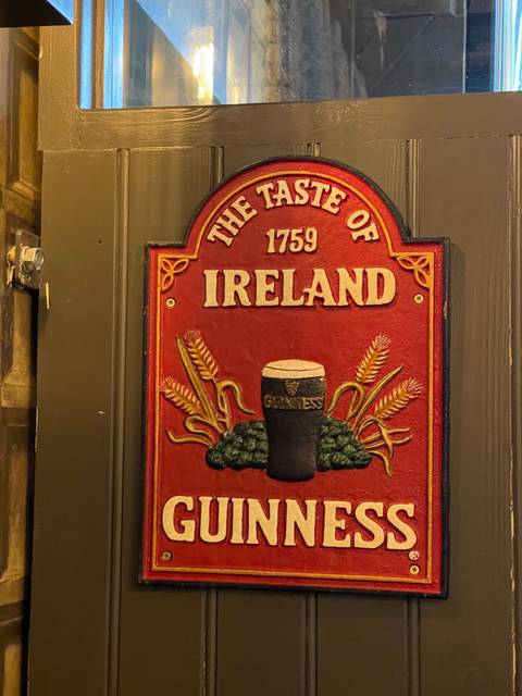 A sign with the Guinness logo reading 'The Taste of Ireland'.