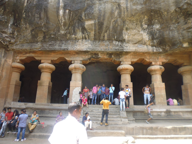 People visiting a cave temple.