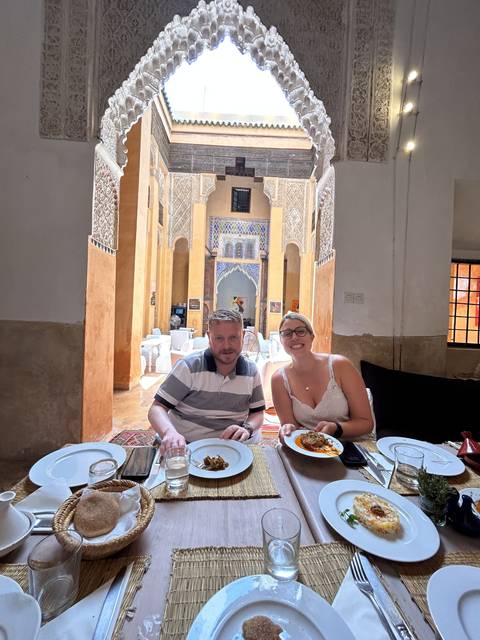 People dining in a traditionally decorated room.