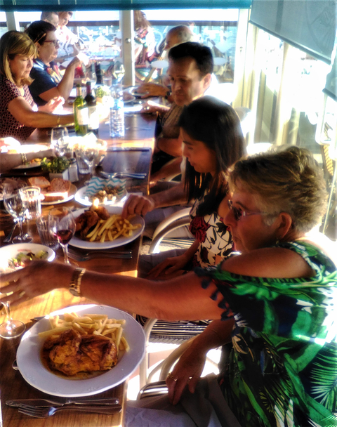 People dining at a table with various dishes.