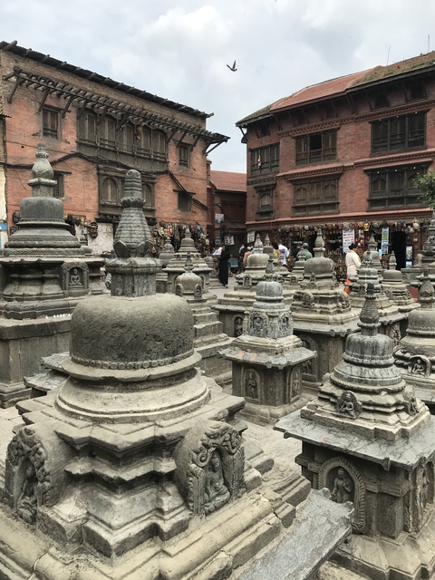 Shrines and stupas in a busy outdoor market.