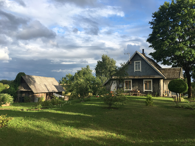 A quaint countryside house surrounded by trees.
