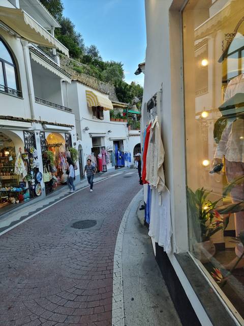Street with small shops and tourists.