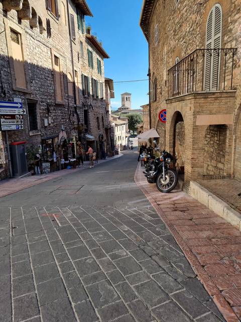 Street scene in a historic city with stone buildings.