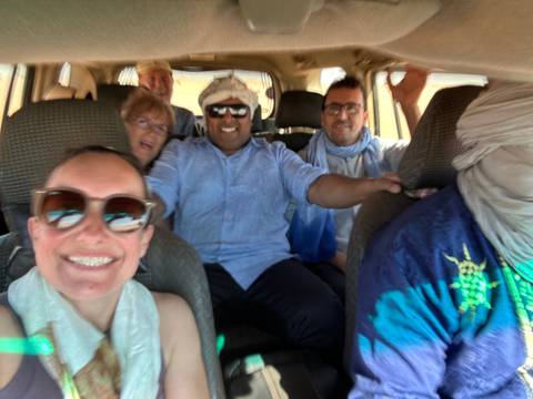 Selfie of group of people inside a vehicle.