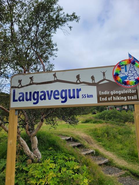 Signpost with distance information on a hiking trail.