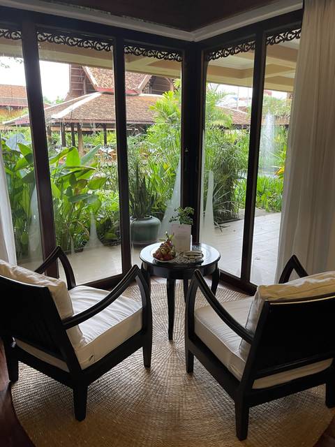 View from a lounge seating area to a tropical garden.
