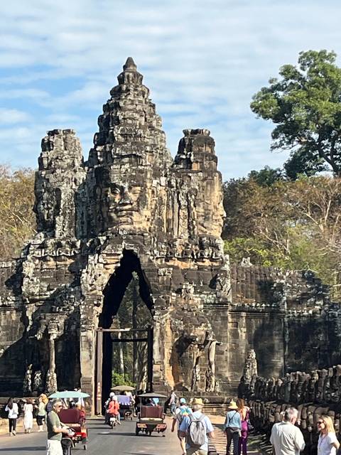 Entrance of an ancient temple with tourists.