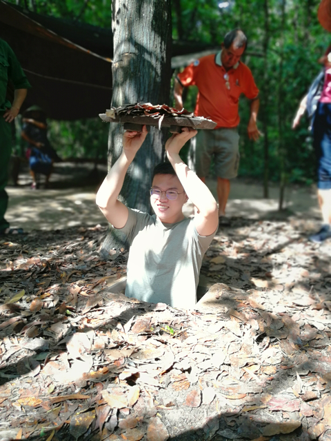 Person emerging from a narrow tunnel.