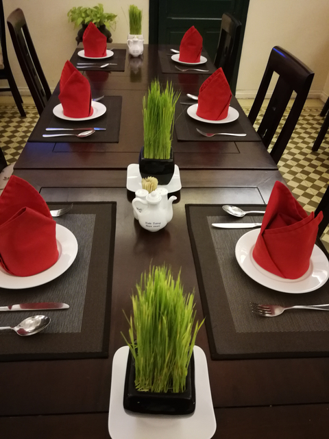 Close-up of a table setting with red napkins.