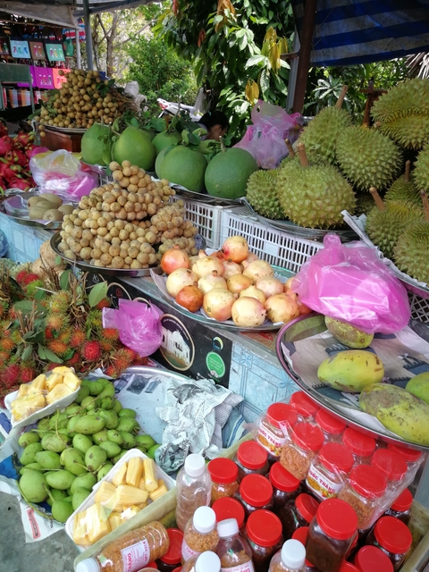 Various fruits displayed at a market stall.