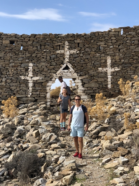 Group of people exploring ruins made of stone.
