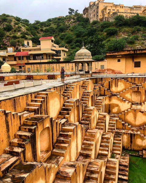 Stepwell with a person walking along the edge.