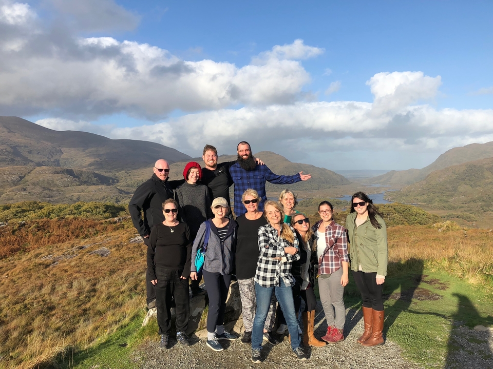Group of tourists enjoying a scenic view in the countryside.