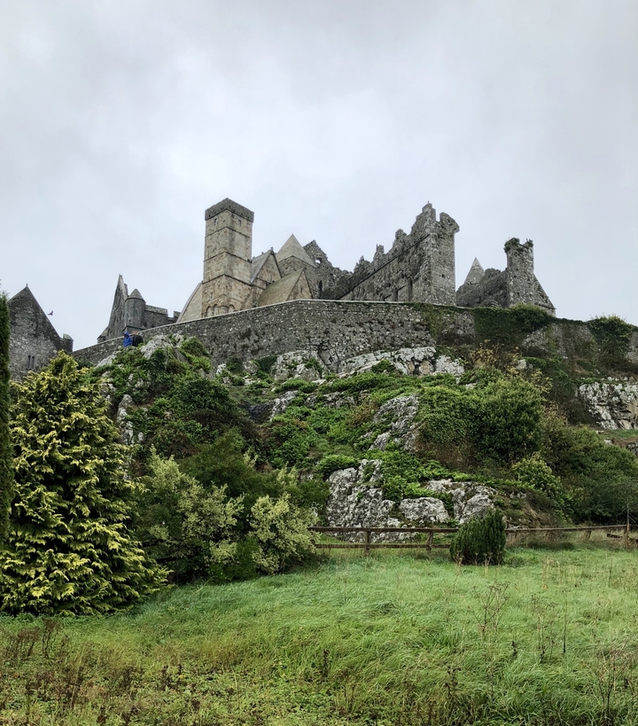 Rock of Cashel on a hill with greenery in Ireland.