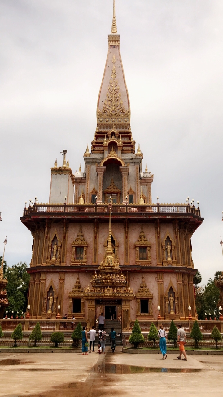 Façade de temple ornée avec décoration dorée et blanche.
