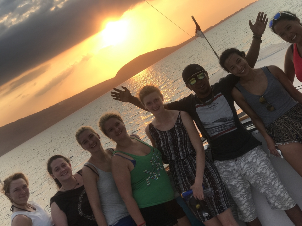 Group of people enjoying a sunset on a boat.