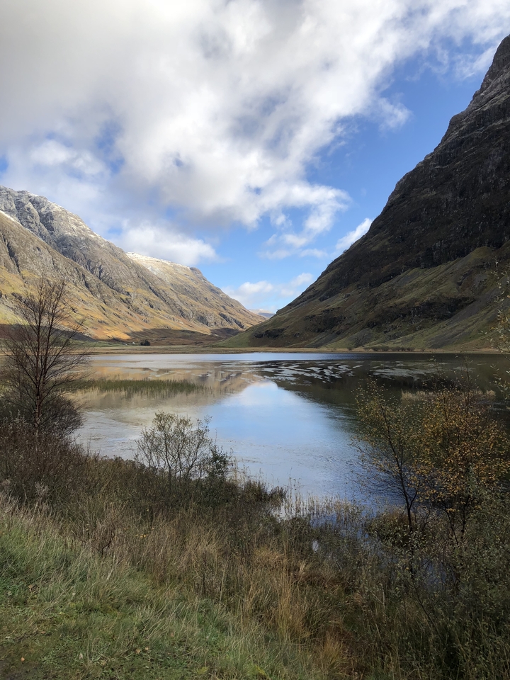 Scenic valley with a lake between mountains.