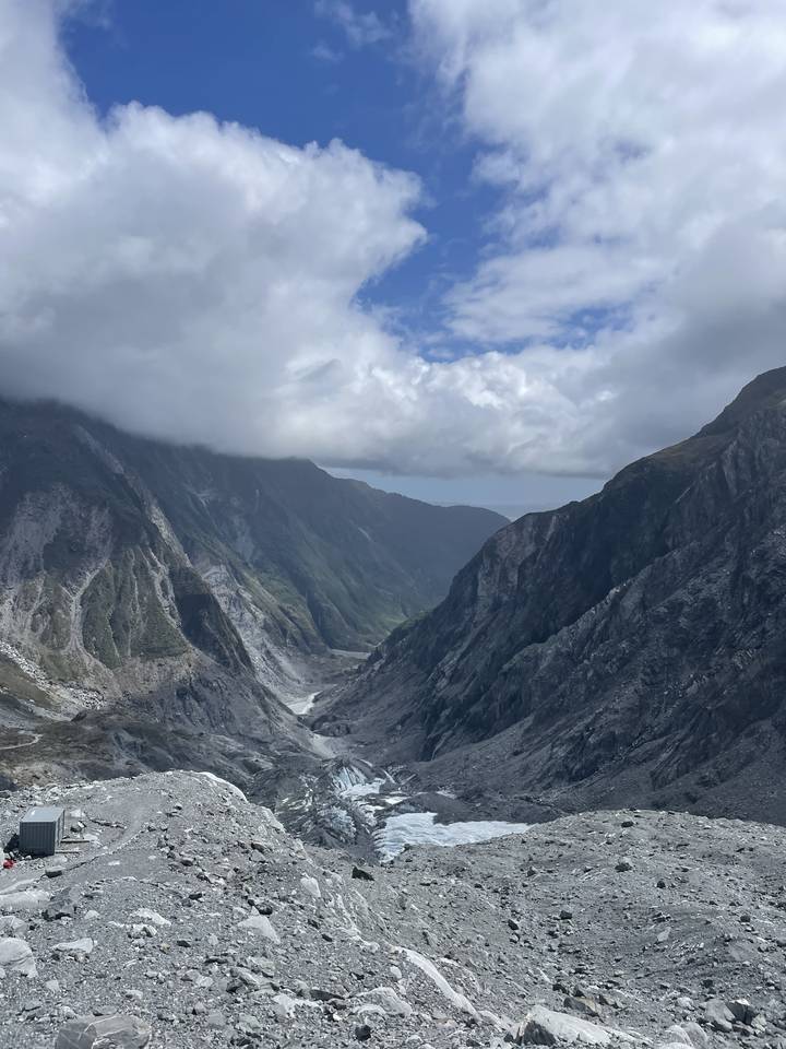 Rocky mountainous landscape with cloudy sky.