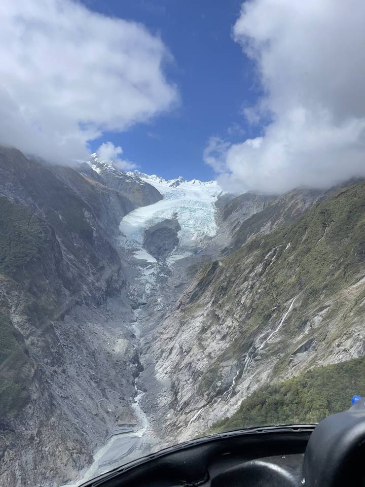 Glacier seen from above with rugged landscape.
