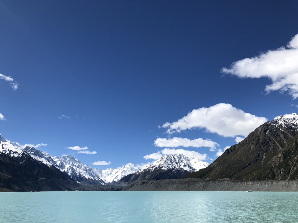 Breathtaking view of snow-capped mountains against a clear blue sky.