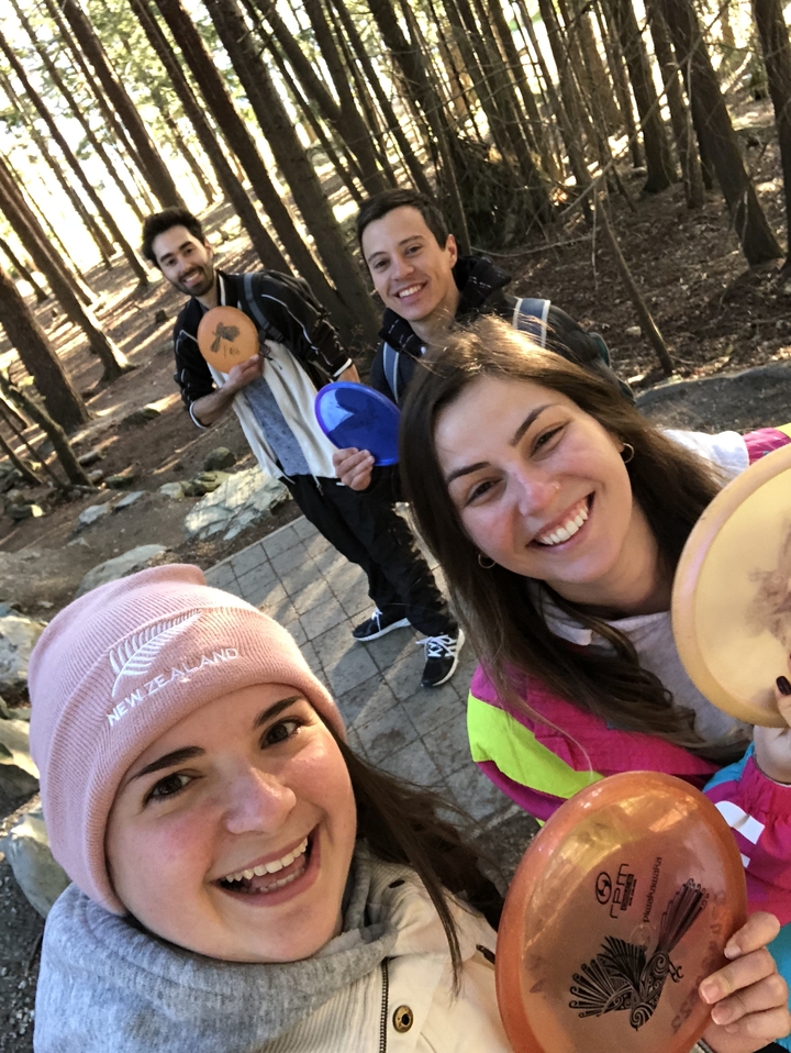 Des amis tenant des disques dans un parc.