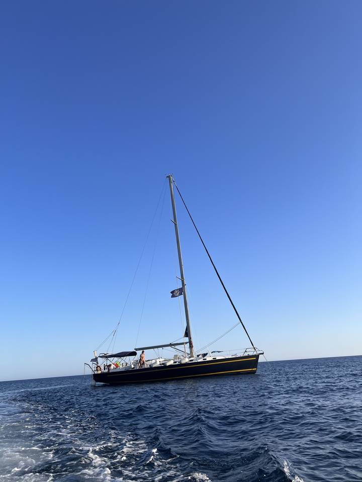 A yacht sailing on clear blue waters.