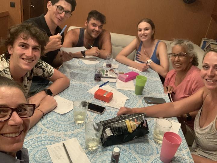 Group of people around a table with game materials.