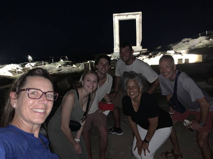 Group of people posing at night with a dark sky.