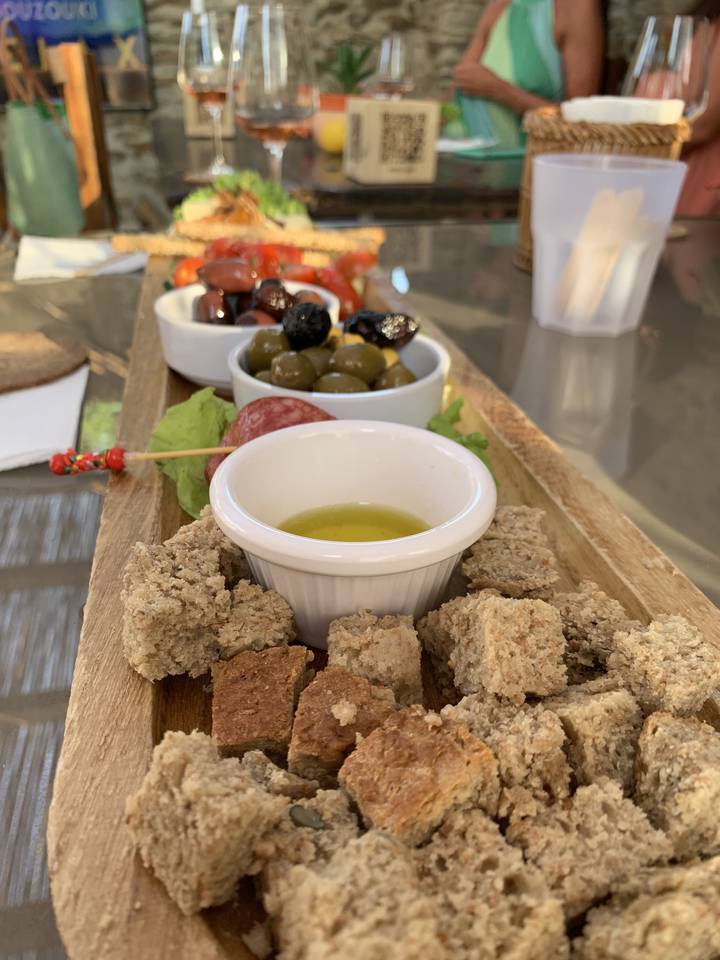 Platter of Mediterranean appetizer with olives and dip.