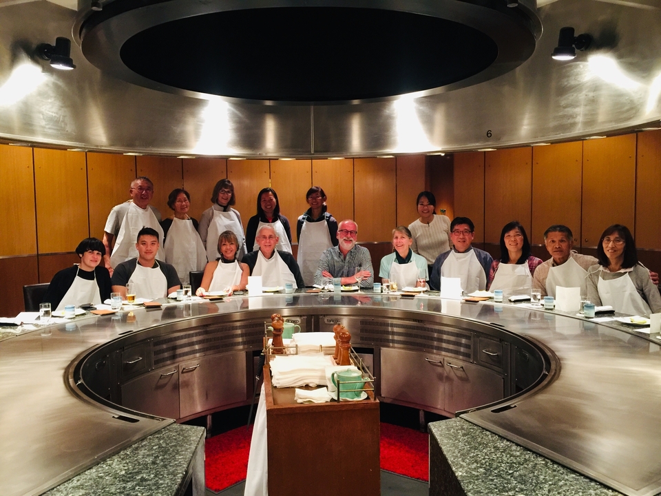 Repas de groupe à une table ronde avec des plats traditionnels.