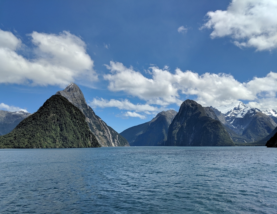 Majestic mountains and lake under a blue sky.