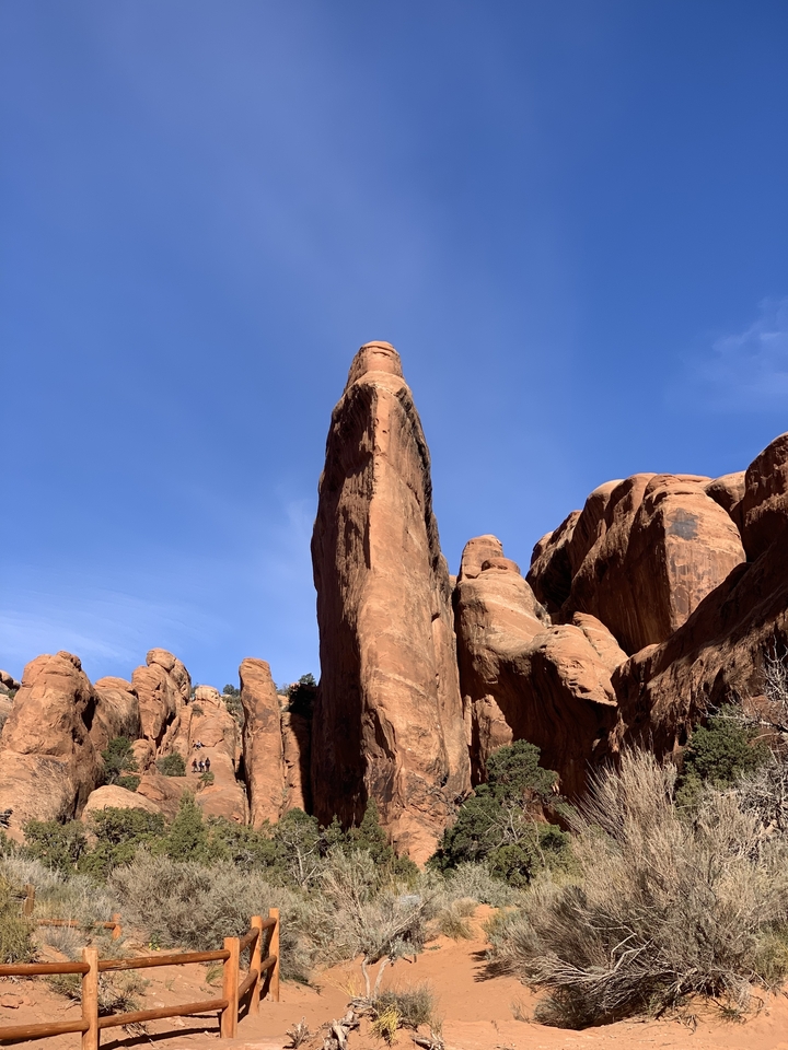 Tall, narrow rock formation against a clear sky.