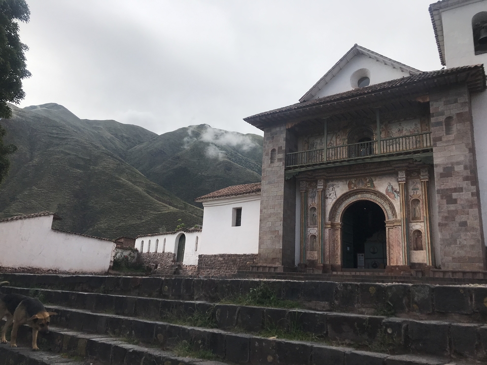 Church with detailed facade surrounded by mountains.
