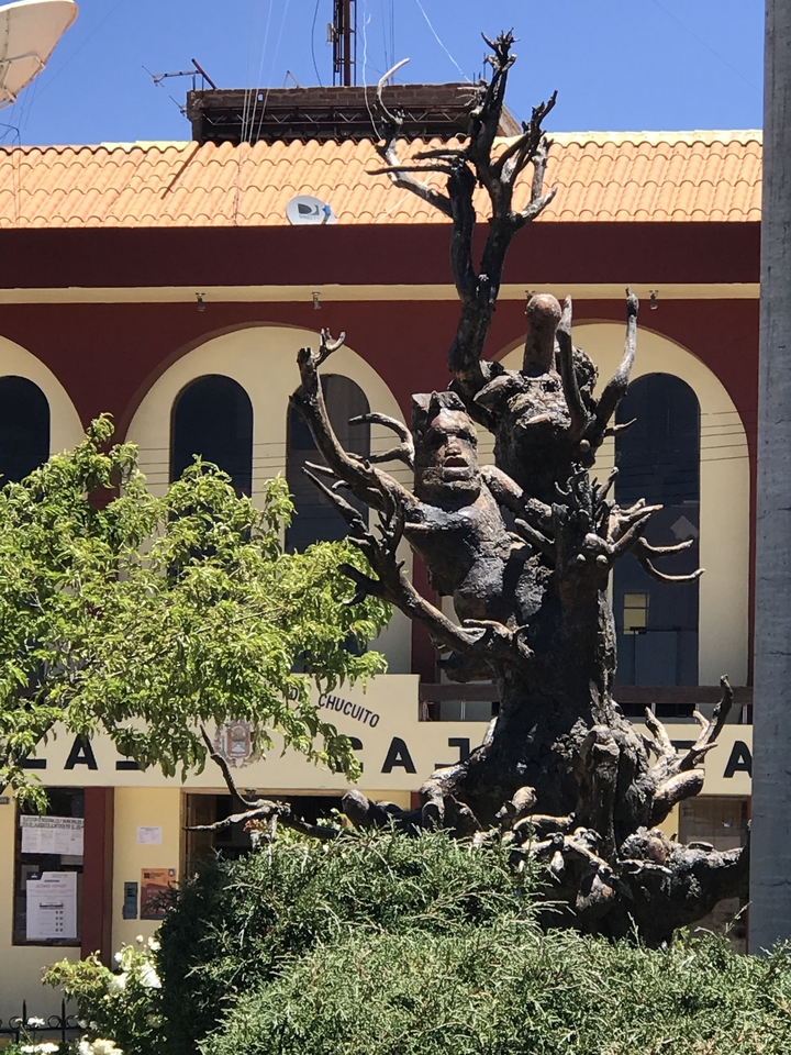 A statue outside a building in a plaza.