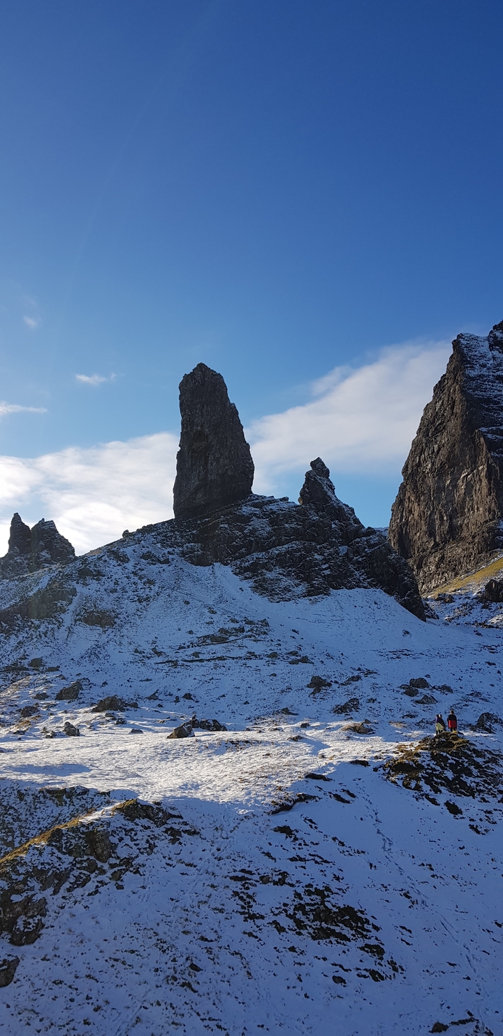 Prominent rock formations in a snowy terrain.