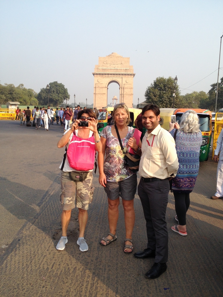 Tourists taking photos in front of India Gate.
