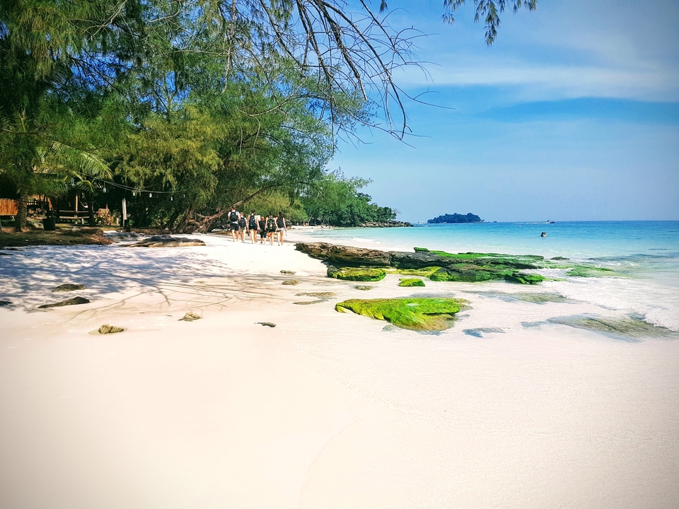 Beach with white sand and clear water.