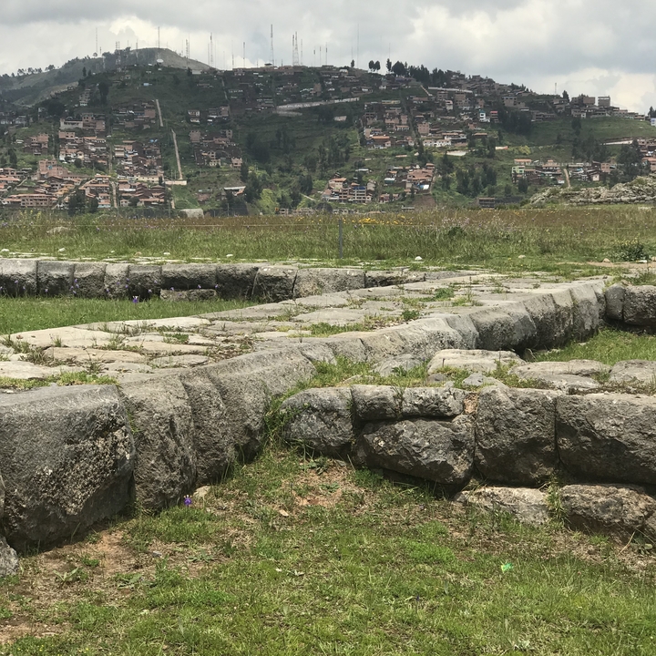 Two people posing in front of stepped terraces.