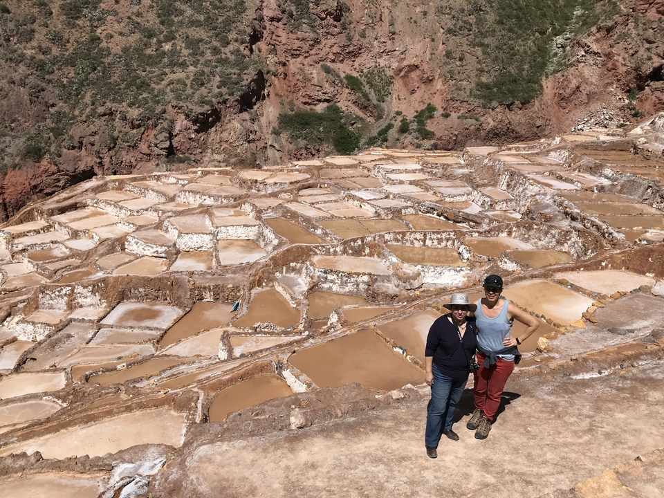 Two people posing in front of saline terraces.