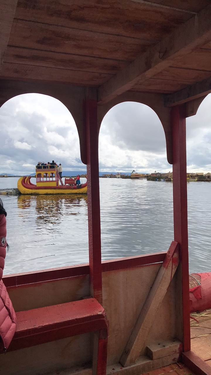 Traditional reed boat with people on Lake Titicaca.