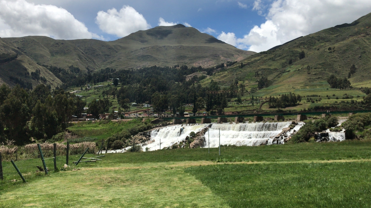 Waterfall in a green mountainous landscape.